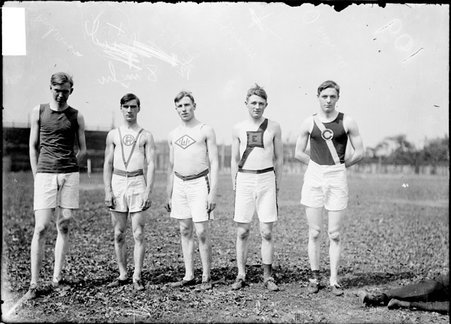 Athletes, O. L. Richards, E. Springer, E. Ludwig, F. Coyle, and E. Anderson standing on the field at Marshall Field - Chicago Daily News, Inc.