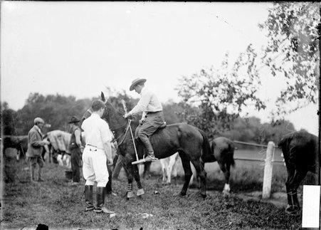 Polo player, Charles G. King, holding a mallet and sitting in the saddle of a polo pony - Chicago Daily News, Inc.