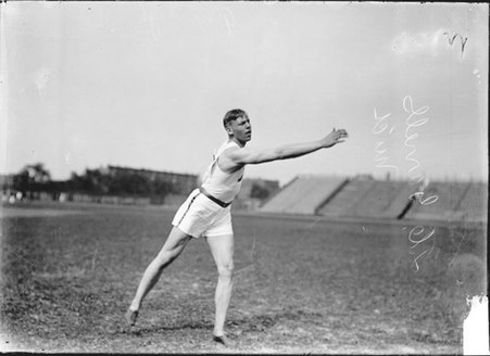 Athlete, J. C. Garrells of University of Minnesota, standing with his right arm extended forward and his right leg extended back - Chicago Daily News, Inc.