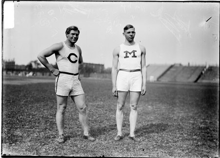 Athletes, Garrells of the University of Minnesota and Perry of the University of Chicago, standing on the field at Marshall Field - Chicago Daily News, Inc.