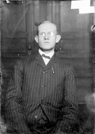 Bowler, George A. Reist, standing in front of a plain backdrop in a room - Chicago Daily News, Inc.