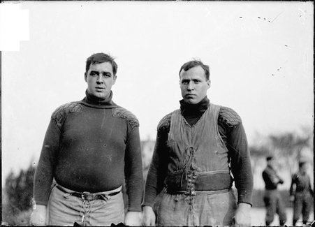 Football players, Carter and Curtis, standing on an athletic field - Chicago Daily News, Inc.