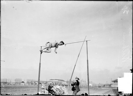 Athlete, pole vaulter L. G. Wilkins, falling in the air after clearing the bar - Chicago Daily News, Inc.