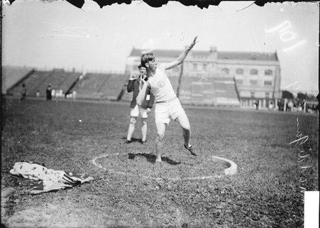 Athlete, Roy Maddigan, throwing a shot put at Marshall Field - Chicago Daily News, Inc.