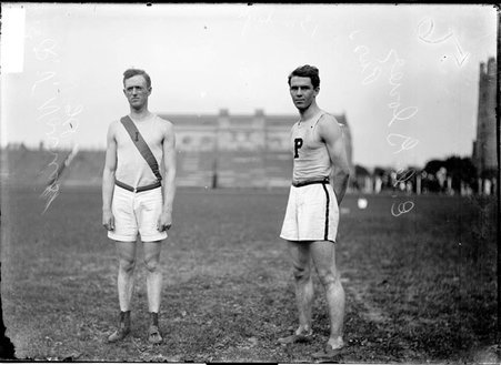 Athletes, E. C. Glover and Ralph Norris, standing on the field at Marshall Field - Chicago Daily News, Inc.