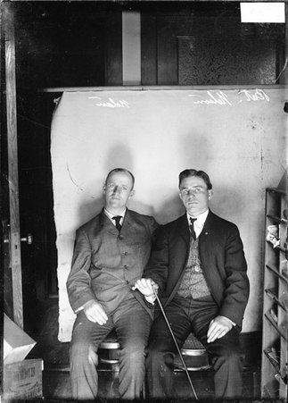 Pugilists, Nolan (on left) and Battling Nelson sitting against a plain backdrop - Chicago Daily News, Inc.