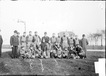 University of Michigan football team and five coaches, posing outdoors - Chicago Daily News, Inc.