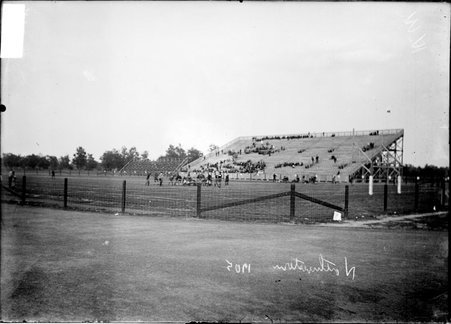 Football, players on the field and spectators sitting in the bleachers at a Northwestern University football game at Marshall Field - Chicago Daily News, Inc.
