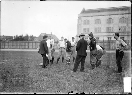 Football coach, Alonzo A. Stagg, University of Chicago, talking to football players, including Walter Eckersall, at Marshall Field - Chicago Daily News, Inc.