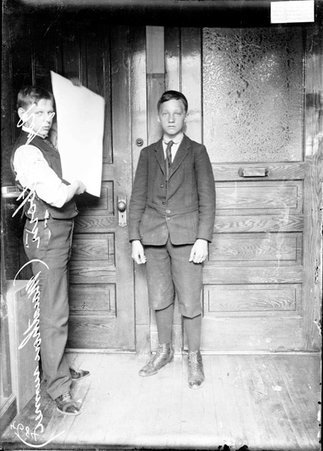 Marathon runner Roy Estborn, standing in front of wooden doors in an office - Chicago Daily News, Inc.
