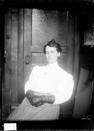 Chess player Mrs. Frank W. Lynn, sitting in a chair in an office - Chicago Daily News, Inc.