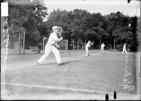 Tennis player R. D. Weberuner, swinging a racquet and running on the court at a tennis club - Chicago Daily News, Inc.
