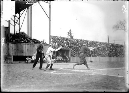 Chicago Cubs catcher Jack O'Neill, catching a ball at home plate at West Side Grounds, player swinging bat in front of him - Chicago Daily News, Inc.