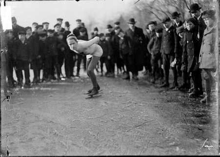 Speed skater, H. Halvor, bending forward with hands behind his back in position to begin a race on a frozen park lake - Chicago Daily News, Inc.