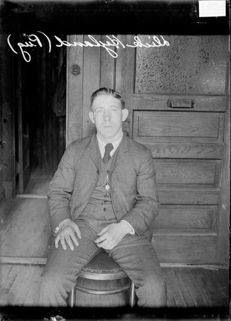 Boxer Dick Hyland, sitting in a chair in an office, facing forward - Chicago Daily News, Inc.