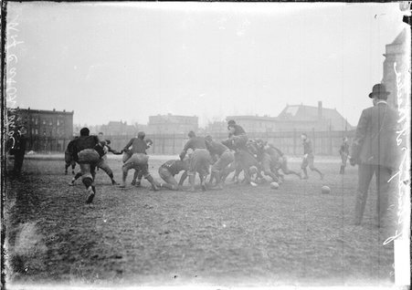 University of Chicago football team practicing on Marshall Field, players are piling on top of each other in the middle of the field - Chicago Daily News, Inc.