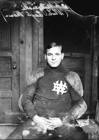 White Eagle football player Julius Wengierski, sitting with his hands clasped in his lap in a chair in an office - Chicago Daily News, Inc.
