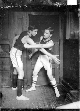 Basketball players, YMCA, C. Plockman and E. Scripp, in blocking positions in a room in the Chicago Daily News building - Chicago Daily News, Inc.