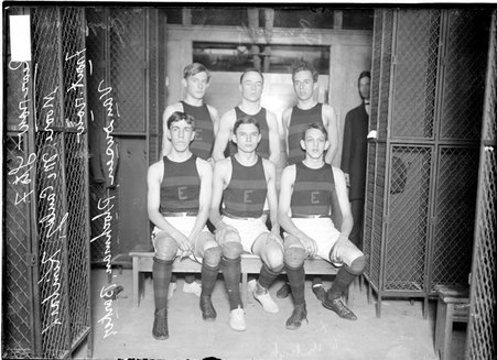 Basketball players, Moore, McCauley, Barker, Kimbark, and VanDoren, three sitting and three standing in a locker room - Chicago Daily News, Inc.