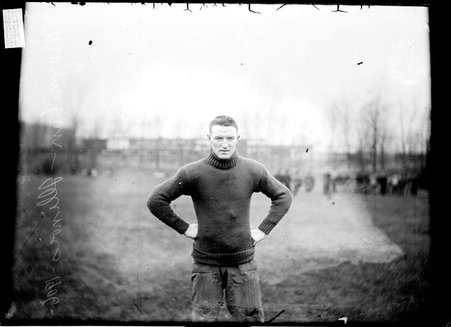 Football player for Illinois, Moynihan, standing on a field - Chicago Daily News, Inc.