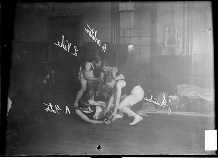 Basketball players, L. Vehe, J. Scanlon, H. Ashton, and R. Gale, Gale lying on floor with three other players standing over him - Chicago Daily News, Inc.