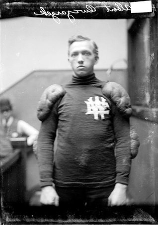 White Eagle football player Albert Owczarzel, standing in a stairwell hallway at the Chicago Daily News building - Chicago Daily News, Inc.