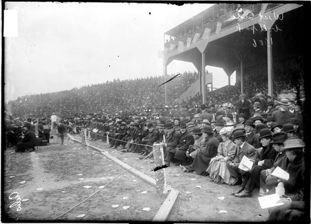 Spectators sitting in overflow seating in front of the grandstand along the first base line at West Side Grounds - Chicago Daily News, Inc.