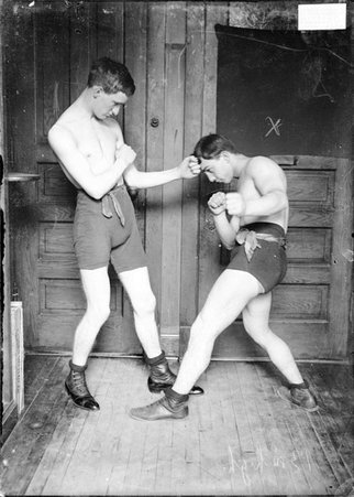 Boxer, Kid Herman, ducking to the side from a left jab given by an unidentified opponent in a room in the Chicago Daily News building - Chicago Daily News, Inc.