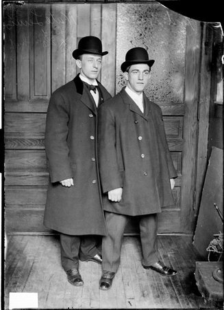 Nate Lewis and unidentified man, standing in front of a door in a room - Chicago Daily News, Inc.