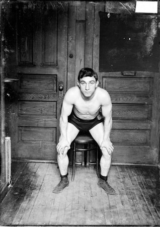 Boxer, Kid Herman, leaning forward with hands on knees in a room in the Chicago Daily News building - Chicago Daily News, Inc.