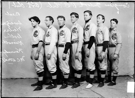 Indoor baseball player, Congress, Driscoll, McDonald, Hieber, Beals, Collins, Kennedy, and Sweitzer, standing in front of a backdrop - Chicago Daily News, Inc.