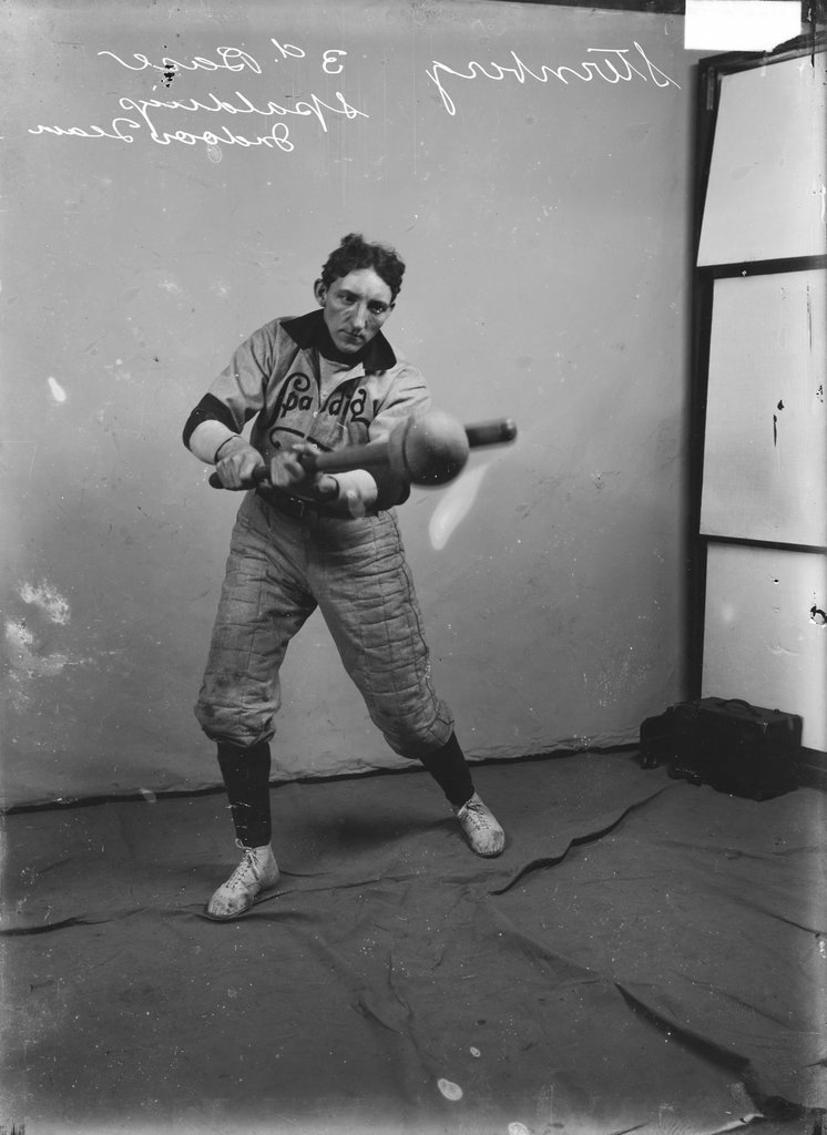 Indoor baseball player, Spalding, F. Sternberg, swinging an indoor baseball bat at an indoor baseball, standing in front of a backdrop - Chicago Daily News, Inc.