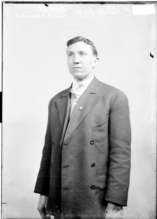 Hull House coach R. C. Tapp standing in front of a light-colored backdrop - Chicago Daily News, Inc.