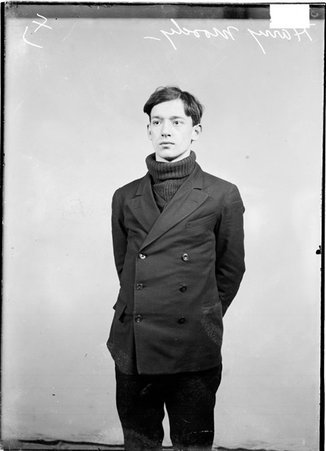 Harry Moody, wearing street clothes, standing in front of a light-colored backdrop in a room - Chicago Daily News, Inc.