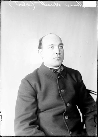 Indoor baseball catcher and team captain, Tom Messitt, Lawndale, sitting in front of a light-colored backdrop in a room - Chicago Daily News, Inc.