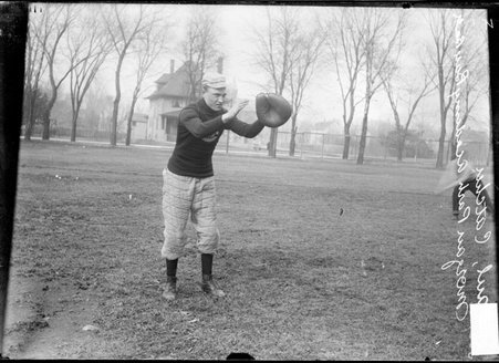 Morgan Park Academy baseball catcher Paul, holding his hands out in front of him, standing on a grass field - Chicago Daily News, Inc.