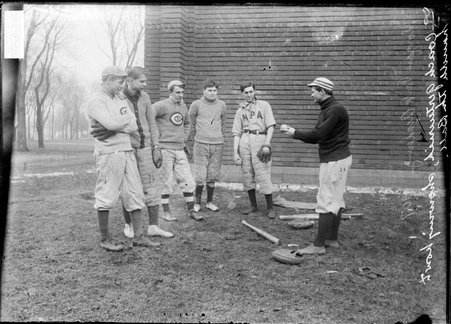 Morgan Park Academy baseball coach Gertenrich, standing with pitcher Needham in front of a Morgan Park Academy building - Chicago Daily News, Inc.