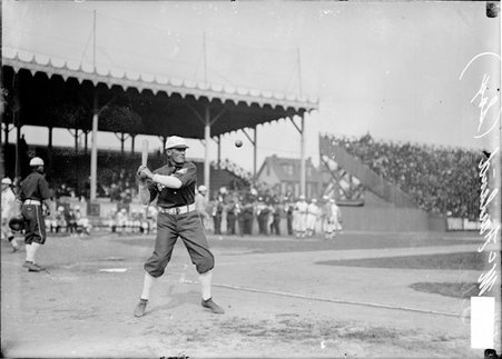 White Sox baseball player Eddie McFarland, eyeing a baseball falling through the air in front of him, standing in a batting stance - Chicago Daily News, Inc.
