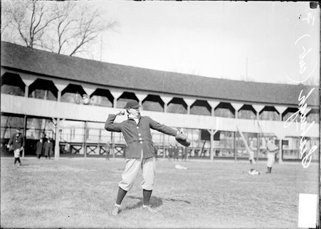 Chicago Cubs baseball player Seabaugh, cocking his arm to throw a baseball, standing on the field during practice at West Baden - Chicago Daily News, Inc.