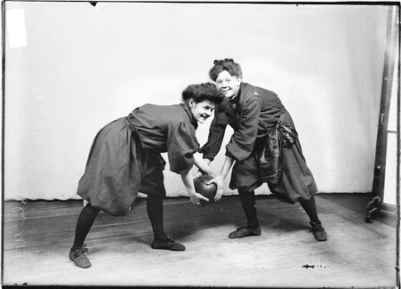 Lincoln Methodist Episcopal basketball players Morahan and Wennie, posing as if fighting for a basketball, in front of a backdrop - Chicago Daily News, Inc.