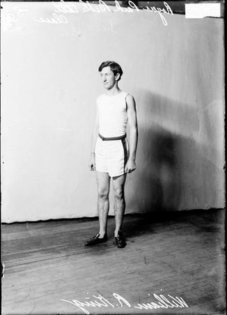 Rogers Park Bible Class athlete William R. Ring, standing in front of a light-colored backdrop in a room - Chicago Daily News, Inc.