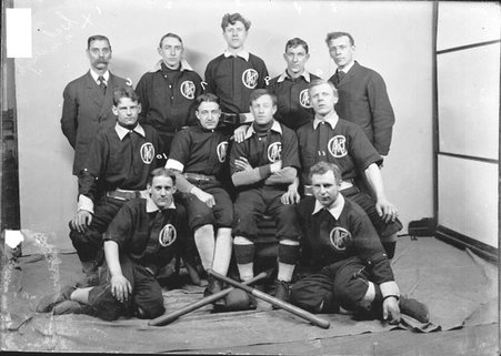 Marquette indoor baseball players, sitting and standing in front of a backdrop - Chicago Daily News, Inc.