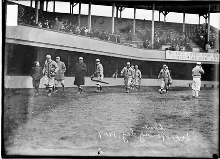 St. Louis Browns baseball players and an unidentified boy, walking in front of the grandstands at South Side Park - Chicago Daily News, Inc.