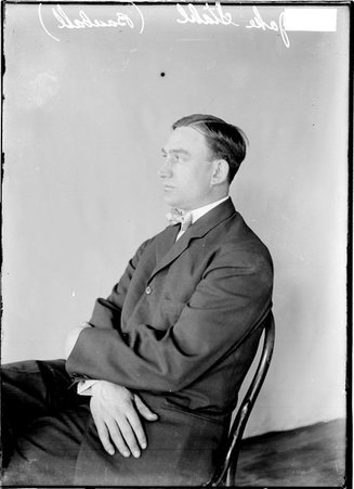 Boston Red Sox baseball player Jake Stahl, sitting in profile in front of a light-colored backdrop in a room - Chicago Daily News, Inc.