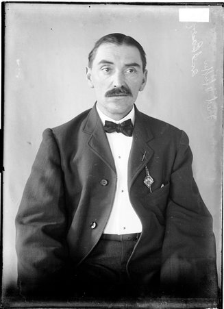 Fred Pfeiffer, former White Sox player, sitting against backdrop - Chicago Daily News, Inc.