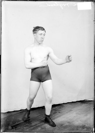 Pugilist, Dick Hyland, facing to right, standing against backdrop - Chicago Daily News, Inc.