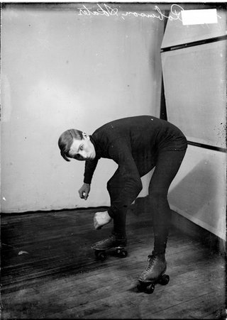 Roller skater, William Robinson, standing in front of a light colored background with his left side to the camera in a room - Chicago Daily News, Inc.