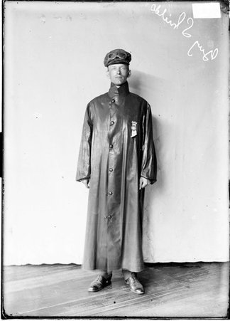 Autoist, Guy Shields, standing against backdrop - Chicago Daily News, Inc.