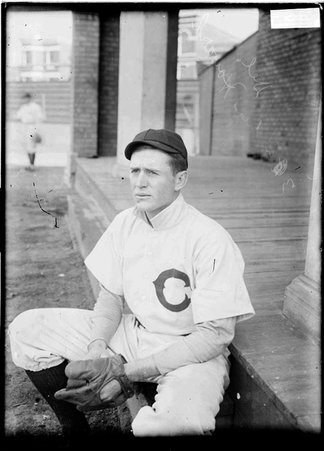 Chicago Cubs baseball player, Del Howard, sitting on a step of a building at West Side Grounds - Chicago Daily News, Inc.