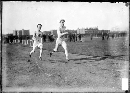 Wendell Phillips High School runners F. Kuhn and O. T. Reiley, racing on the athletic track at Marshall Field - Chicago Daily News, Inc.